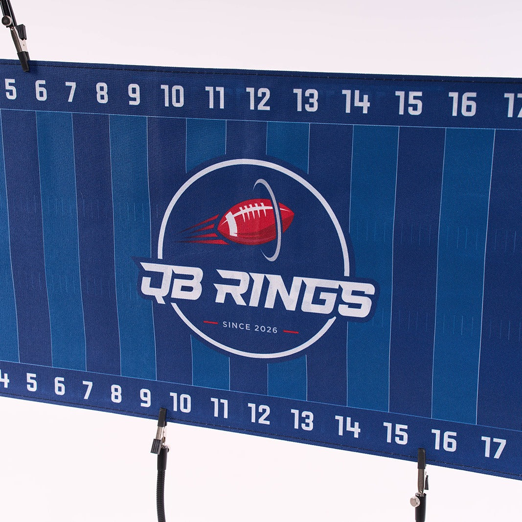 Close-up of the QB Rings yard-line field banner with the QB Rings logo