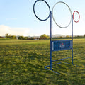 QB Rings game set up at full height on a grass field: blue, white and red rings above the yard-line banner