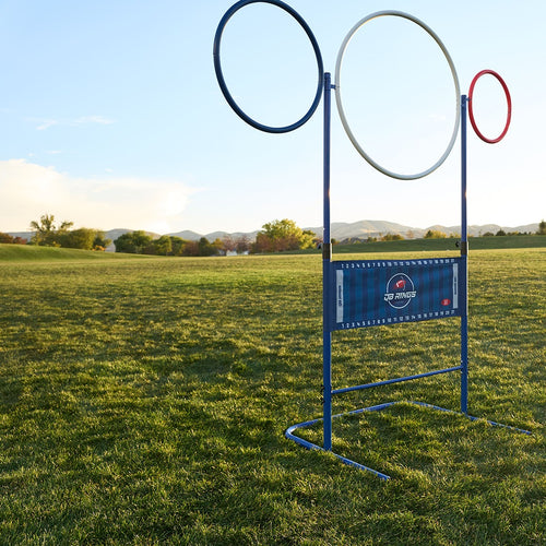 QB Rings game set up at full height on a grass field: blue, white and red rings above the yard-line banner