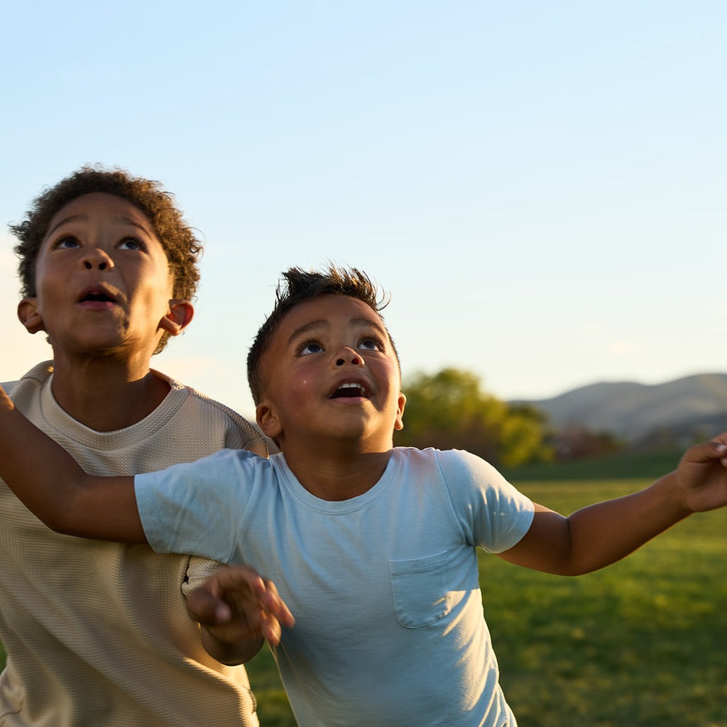 Two kids looking up to catch a pass during a game of QB Rings